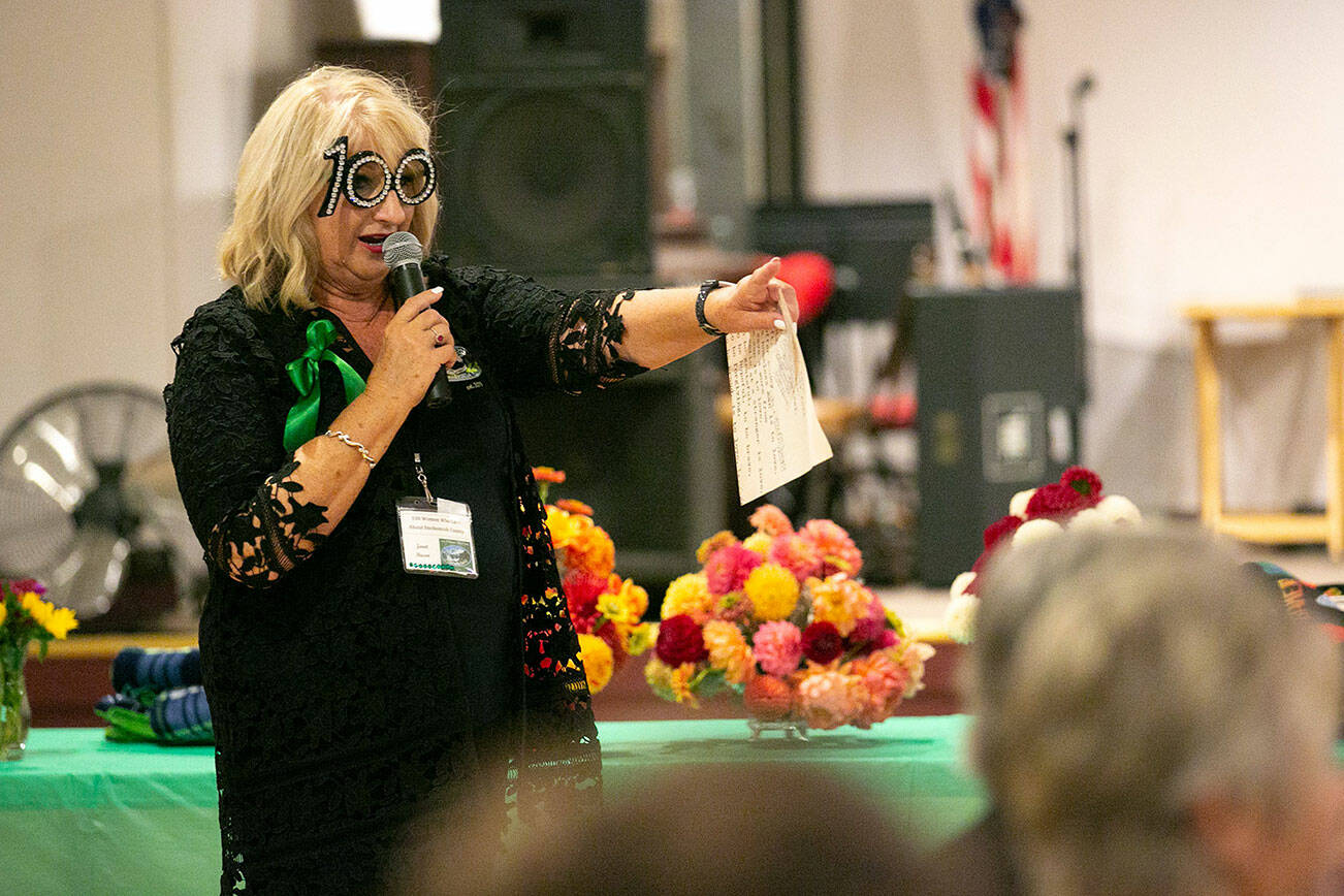 Janet Bacon leads the night during 100 Women Who Care About Snohomish County’s Giving Circle meeting Wednesday, Oct. 5, 2022, at the Sons of Norway Normanna Lodge #3 in Everett, Washington. (Ryan Berry / The Herald)