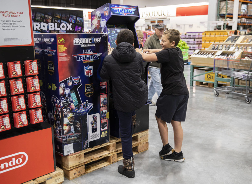 Two boys plays a video game display at Costco on Friday, Dec. 2, 2022 in Lake Stevens, Washington. (Olivia Vanni / The Herald)
