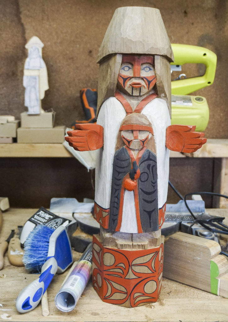A small model of Ty Juvinel’s welcome figure sits on display in his workshop on Wednesday, Dec. 1, 2022 in Tulalip, Washington. (Kayla Dunn / The Herald)

