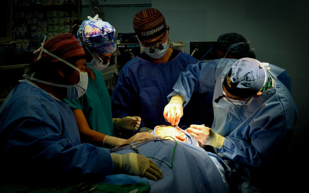 Dr. Prabhat Bhama performs surgery on a child with microtia in a Guatemalan hospital with a team of New York-based HUGS foundation medical volunteers in 2016. Bhama is a facial plastic surgeon at Providence Regional Medical Center in Everett. His wife, Trish, is an nurse practitioner with experience in general surgery and aesthetics. They are part of a nationwide HUGS team working together for a week in Antigua to provide free reconstructive ear surgery to children, many who travel for miles and wait days for a chance at a surgery they would otherwise not get. (HUGS) 
