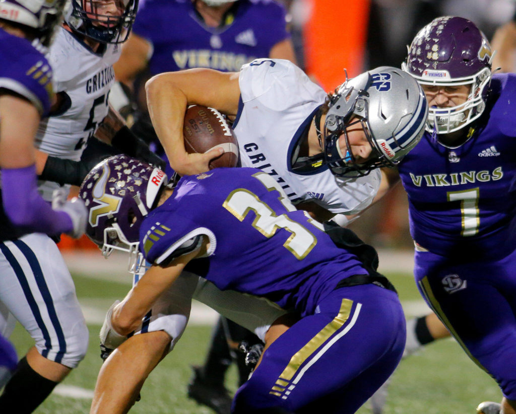 Lake Stevens free safety David Brown delivers a hit on Glacier Peak quarterback River Lien. (Ryan Berry / The Herald)
