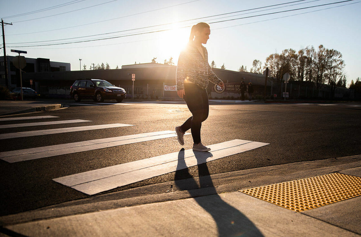 A pedestrian uses the cross walk near Lake Stevens High School