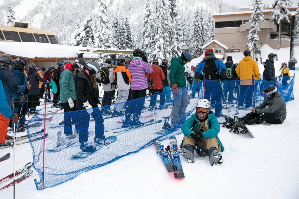 A few people take a breather as others hop in line for a lift. (Ryan Berry / The Herald)
