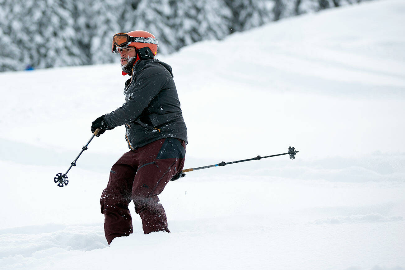 A skier heads down the mountain on the opening day of ski season at Stevens Pass Ski Area on Friday, Dec. 2, 2022, near Skykomish, Washington. (Ryan Berry / The Herald)