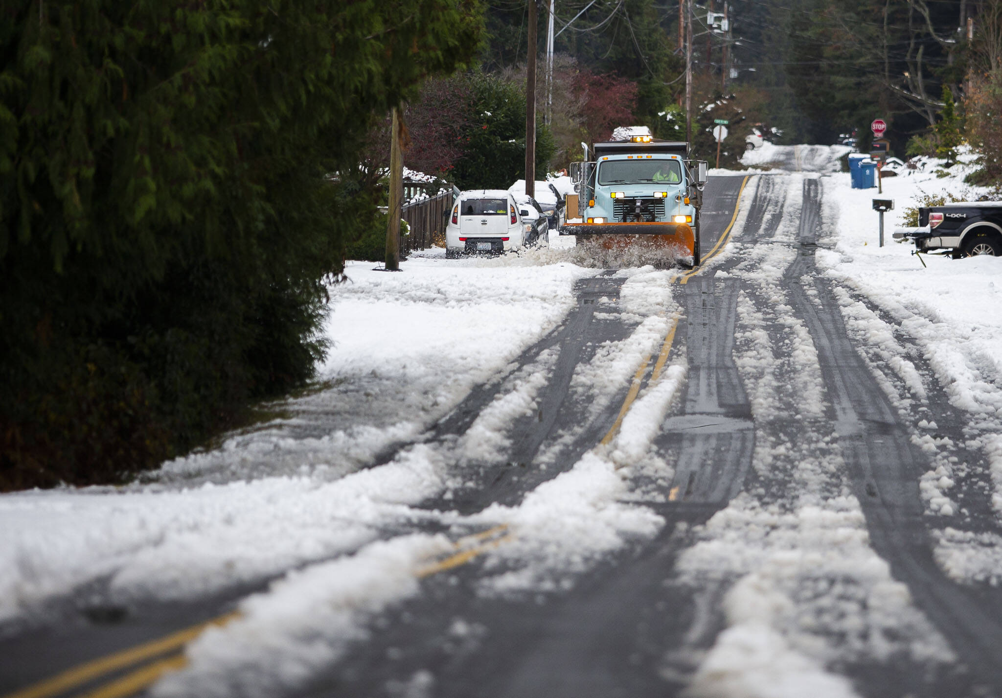 A snow plow clears snow off of 92nd Avenue West on Wednesday, Nov. 30, 2022 in Edmonds, Washington. (Olivia Vanni / The Herald)