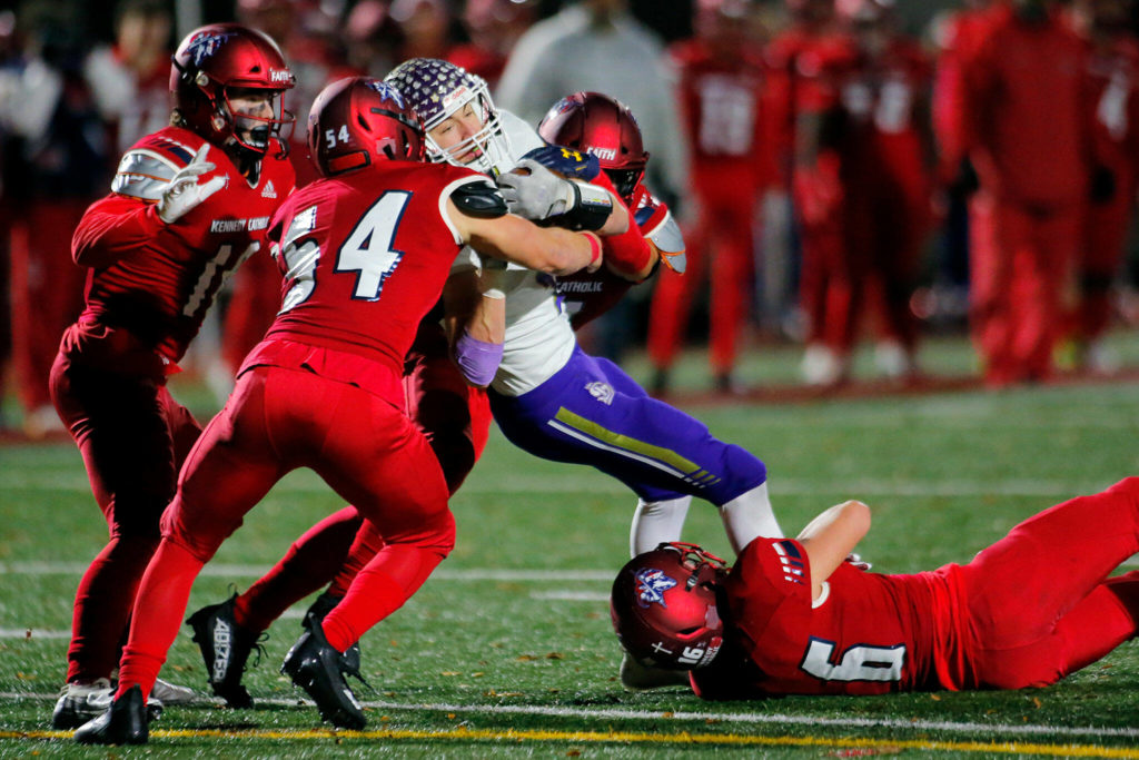 Lake Stevens’ Cole Becker gets tackled after a catch against Kennedy Catholic in the WIAA 4A State Football Championship game Saturday, Dec. 3, 2022, at Mount Tahoma Stadium in Tacoma, Washington. (Ryan Berry / The Herald)
