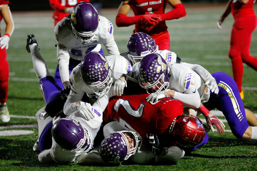 A gang of Lake Stevens defenders stop Xe’Ree Alexander against Kennedy Catholic in the WIAA 4A State Football Championship game Saturday, Dec. 3, 2022, at Mount Tahoma Stadium in Tacoma, Washington. (Ryan Berry / The Herald)
