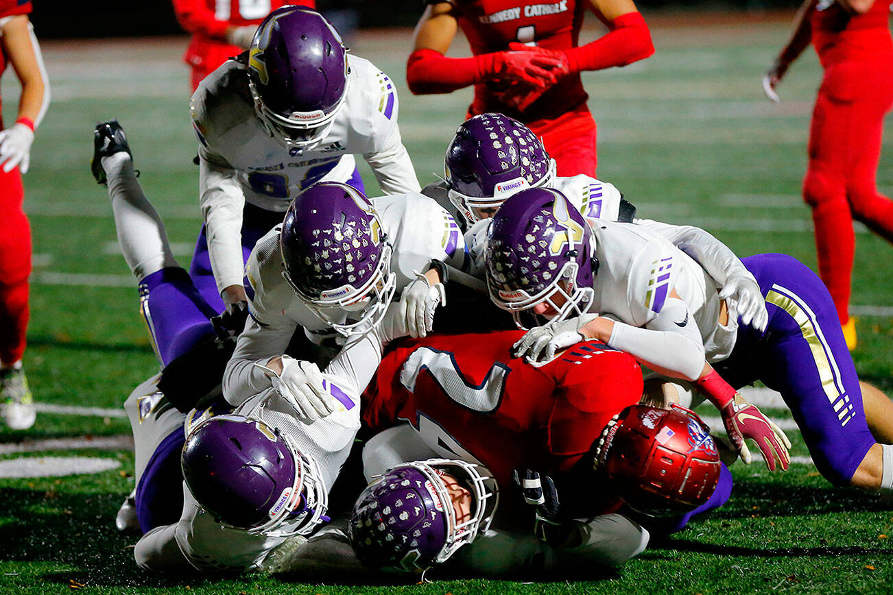 A gang of Lake Stevens defenders stop Xe'Ree Alexander against Kennedy Catholic in the WIAA 4A State Football Championship game Saturday, Dec. 3, 2022, at Mount Tahoma Stadium in Tacoma, Washington. (Ryan Berry / The Herald)