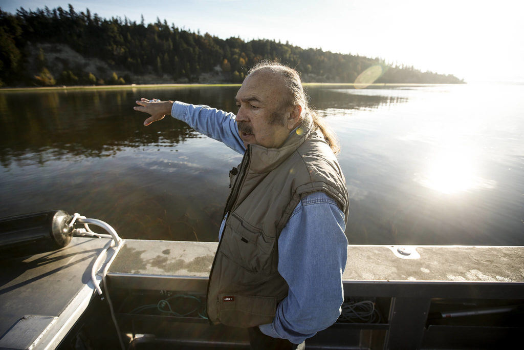 Terry Williams points out a steep hillside near Mission Beach that has been gradually eroding for years. (Ian Terry / The Herald)
