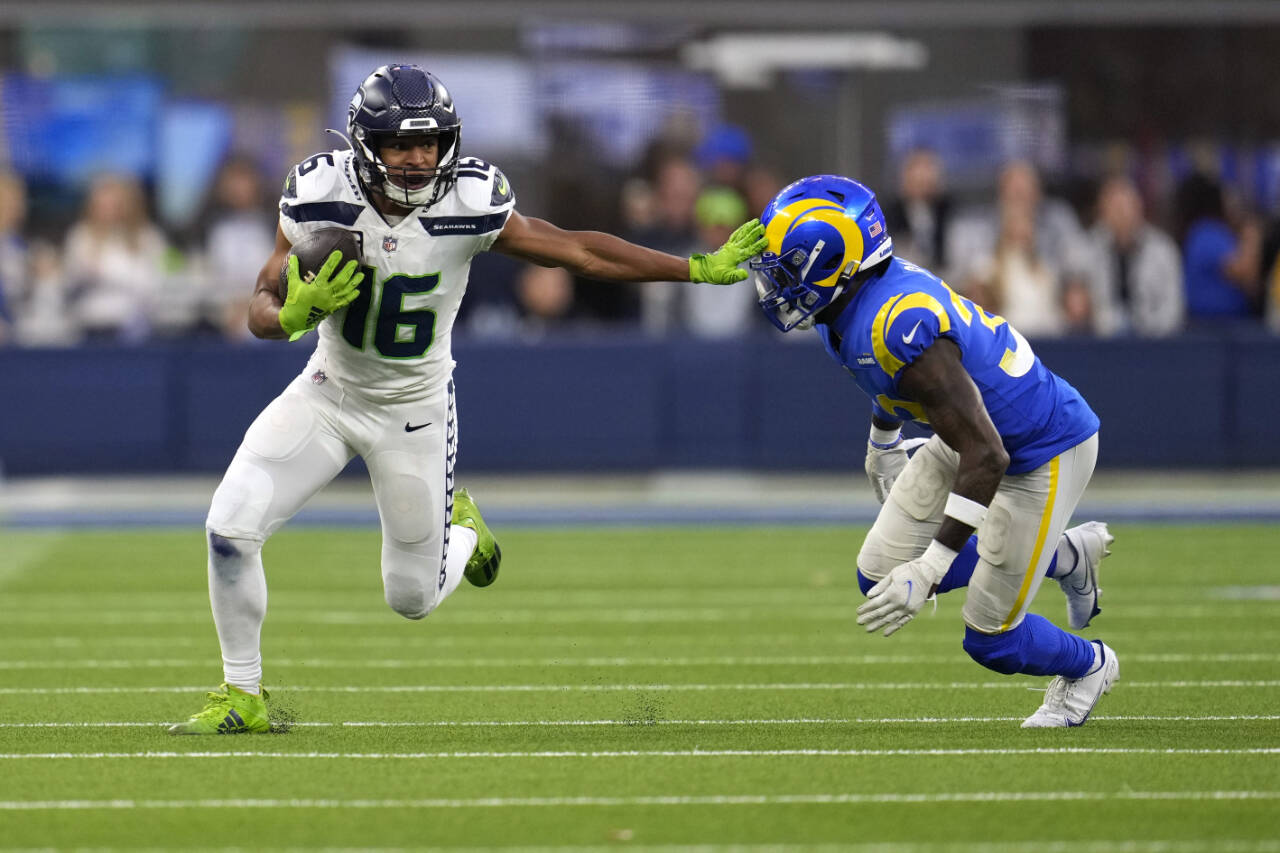 Seattle Seahawks wide receiver Tyler Lockett runs with the ball as Los Angeles Rams safety Nick Scott defends during the second half of a game Sunday in Inglewood, Calif. (AP Photo/Marcio Jose Sanchez)