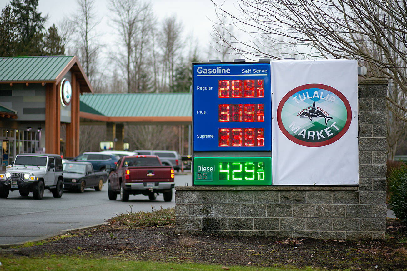 Vehicles come and go from a busy Tulalip Market gas station as the price for regular unleaded drops to $2.99 Thursday, Dec. 8, 2022, in Tulalip, Washington. (Ryan Berry / The Herald)