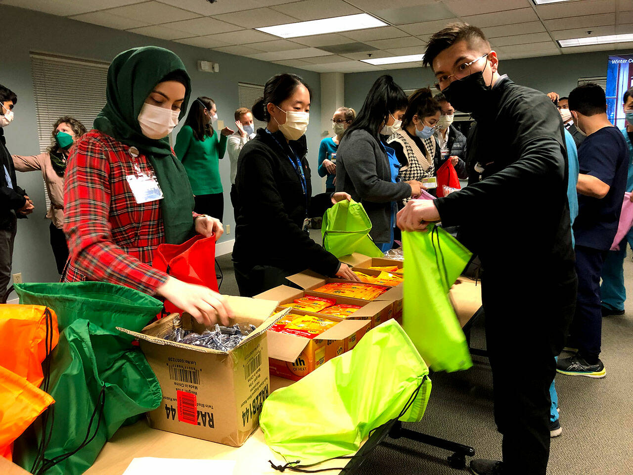 Providence-WSU residents assemble street medicine kits at Providence Regional Medical Center. (Joy Borkholder / The Herald)