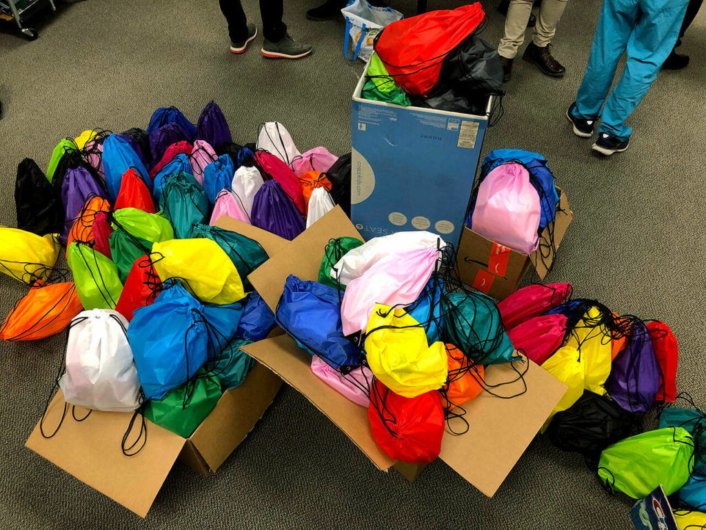 A rainbow of 125 street medicine kits ready for the Lynnwood Hygiene Center. (Joy Borkholder / The Herald)
