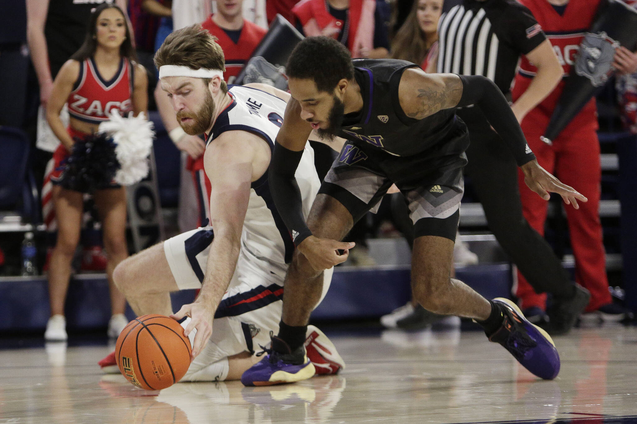 Gonzaga forward Drew Timme (left) and Washington guard PJ Fuller II battle for a loose ball during the first half of a game Friday in Spokane. (AP Photo/Young Kwak)