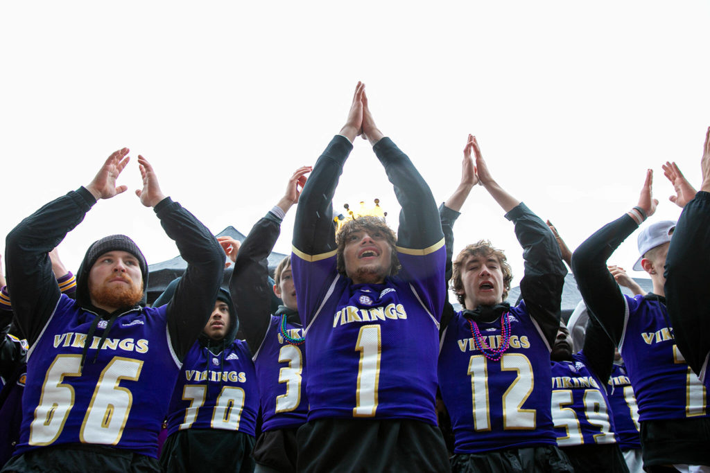 Lake Stevens football players help lead the crowd in a cheer during their 4A football championship parade Saturday, Dec. 10, 2022, in Lake Stevens, Washington. (Ryan Berry / The Herald)
