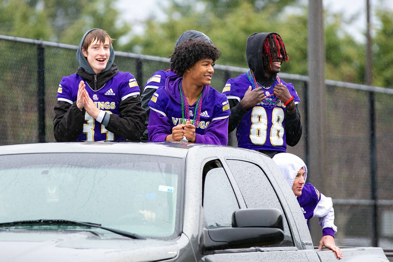 Lake Stevens football players ride in the back of a truck during their championship parade Saturday, Dec. 10, 2022, in Lake Stevens, Washington. (Ryan Berry / The Herald)