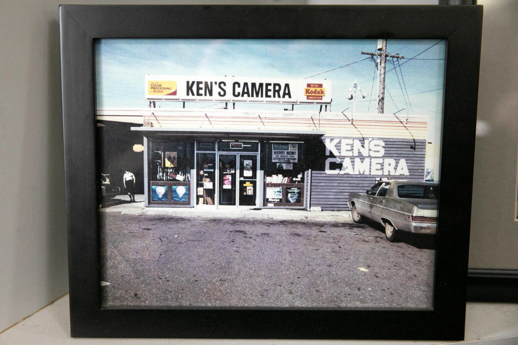 An old photo of the original Ken’s Camera in Lynnwood is tucked away behind the counter at the Evergreen location on Thursday, Dec. 15, 2022, in Everett, Washington. (Ryan Berry / The Herald)
