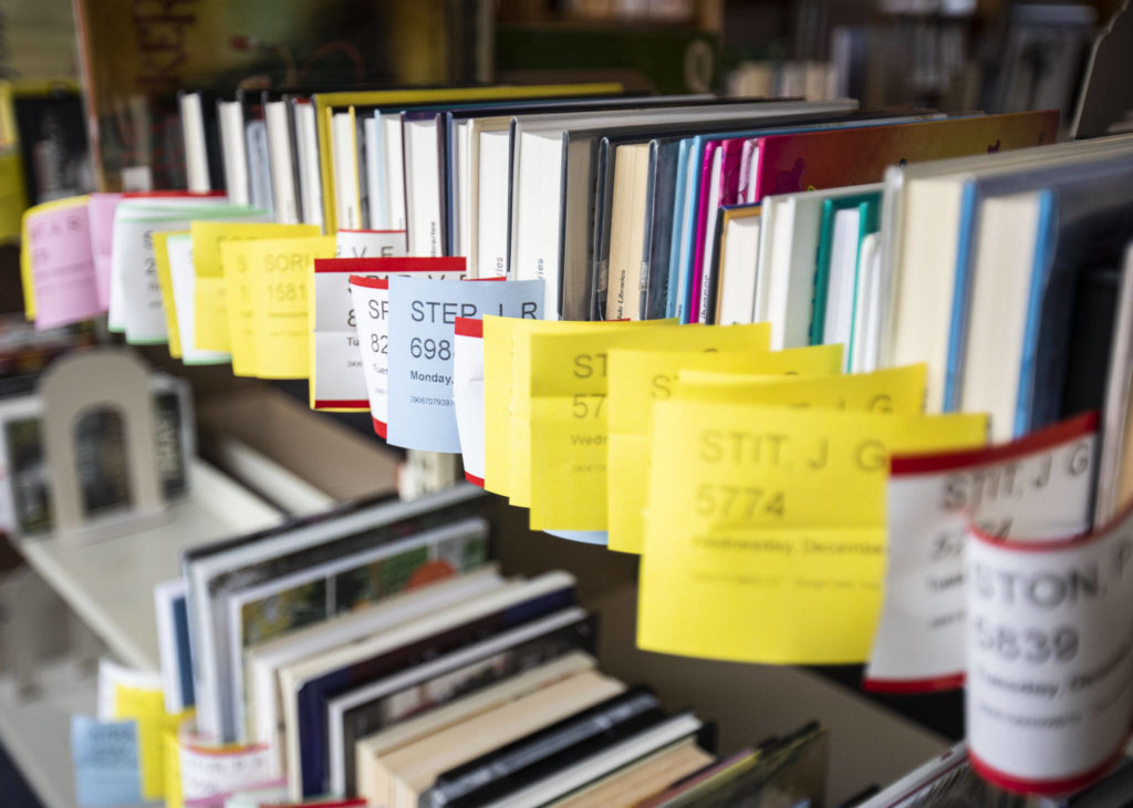 Books on hold available for pickup at the Edmonds Pop-Up Library on Thursday, in Edmonds. (Olivia Vanni / The Herald)
