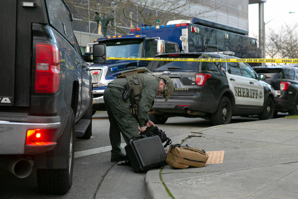 A member of the bomb squad prepares some gear during a lockdown at the Snohomish County Courthouse on Monday, in downtown Everett. (Ryan Berry / The Herald)
