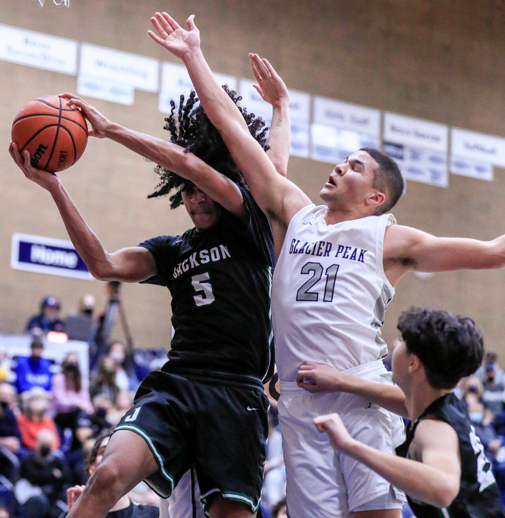 Jackson’s Sylas Williams pulls down a rebounds against Glacier Peak during a game on Jan. 21 in Snohomish. (Kevin Clark / The Herald)
