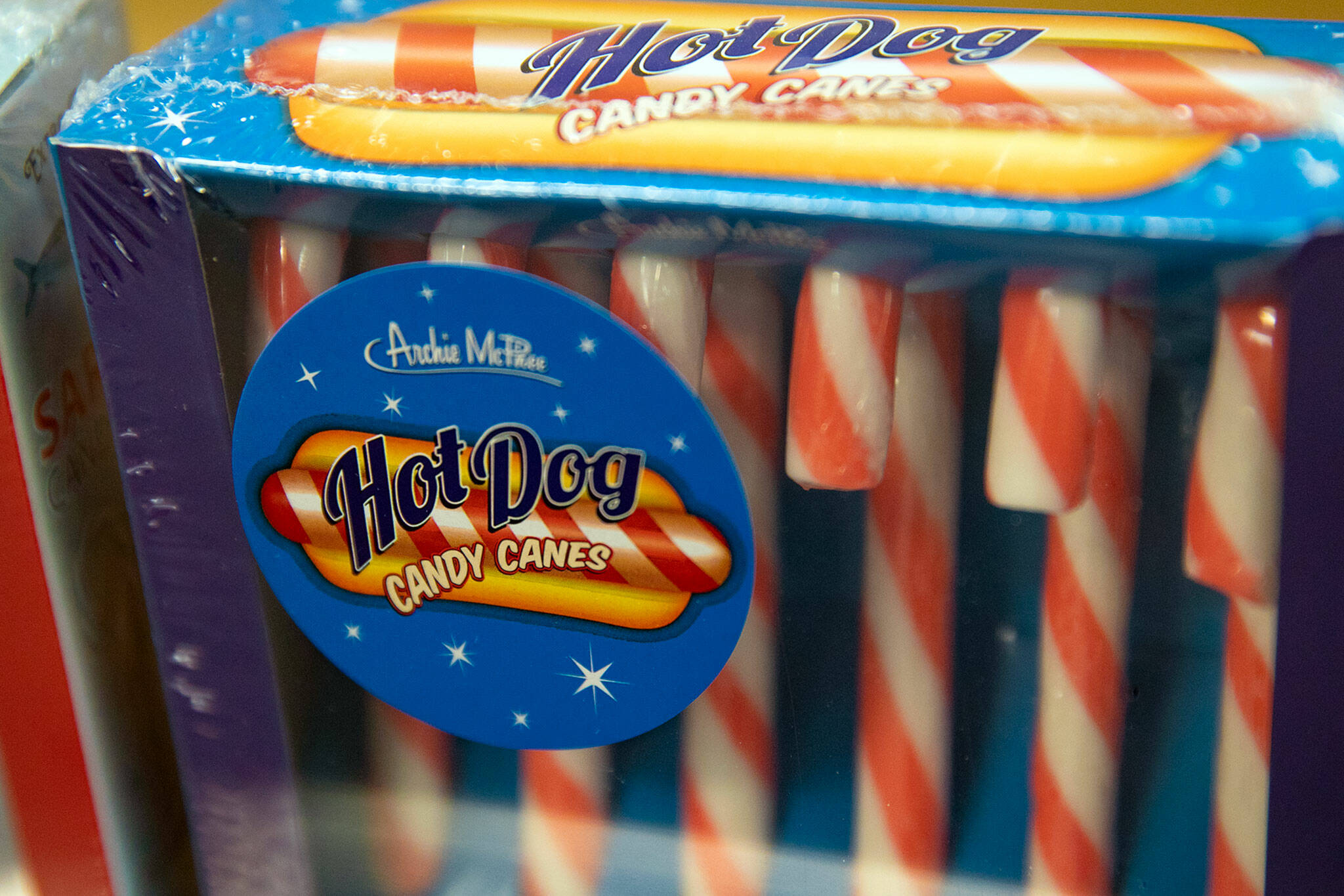 A pack of hot dog candy canes, which look suspiciously like a normal candy canes but have a taste reminiscent of the water left over from boiling some franks, sits on a shelf at the Archie McPhee wholesale building. (Ryan Berry / The Herald)