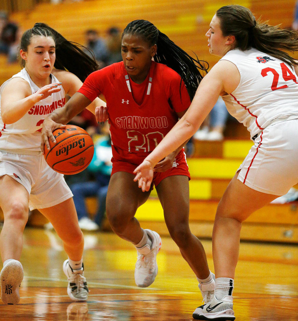 Stanwood’s Chloe Santeford splits the defense on her way to the basket against Snohomish on Feb. 15 at Marysville Pilchuck High School. (Ryan Berry / The Herald)
