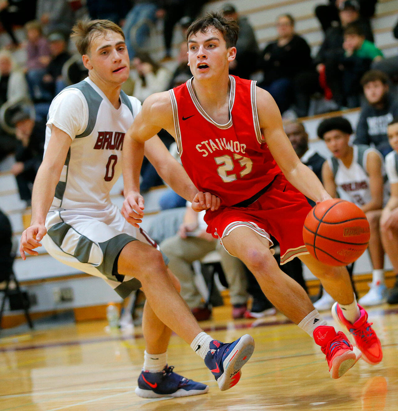 Stanwood’s Cole Williams dribbles past a defender on his way to the net against Cascade on Thursday, Dec. 8, 2022, at Cascade High School in Everett, Washington. (Ryan Berry / The Herald)
