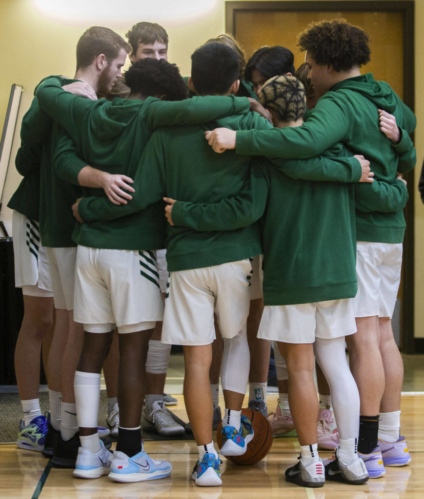 The Shorecrest players huddle before the game on Friday, Dec. 16, 2022 in Marysville, Washington. (Olivia Vanni / The Herald)
