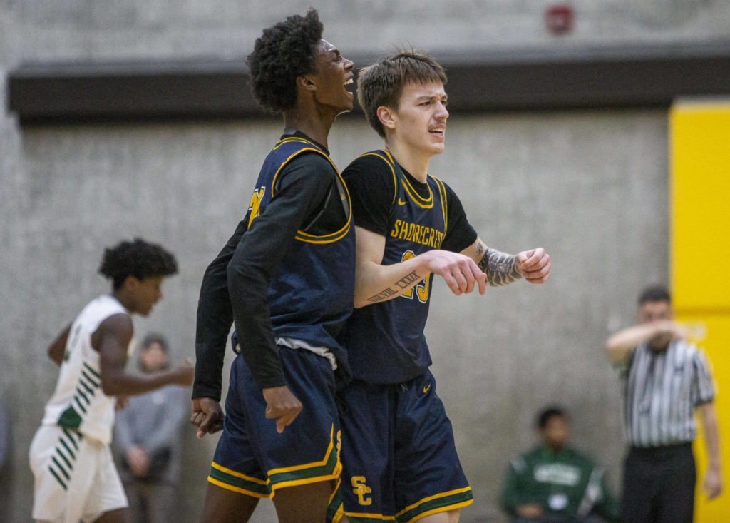 Shorecrest’s Adarrius Hilliard celebrates with Parker Baumann after making a 3-point shot during the game against Marysville Getchell on Friday, Dec. 16, 2022 in Marysville, Washington. (Olivia Vanni / The Herald)
