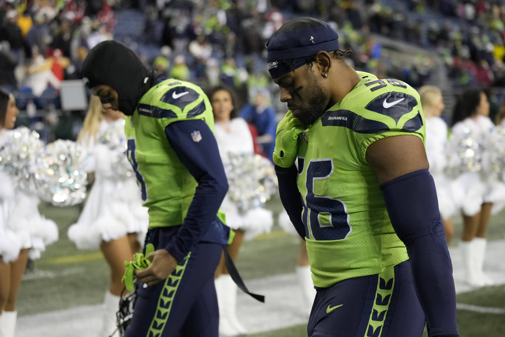 Seahawks cornerback Coby Bryant (left) and linebacker Jordyn Brooks walk off the field after a game against the 49ers on Thursday night in Seattle. (AP Photo/Stephen Brashear)