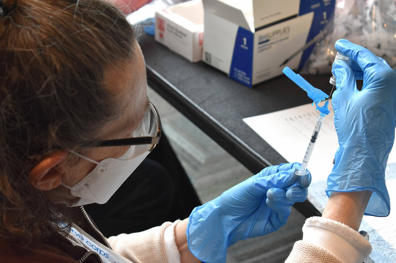 A covid-19 vaccine is prepared for injection at Angel of the Winds Arena in March, 2021. (Snohomish Health District)