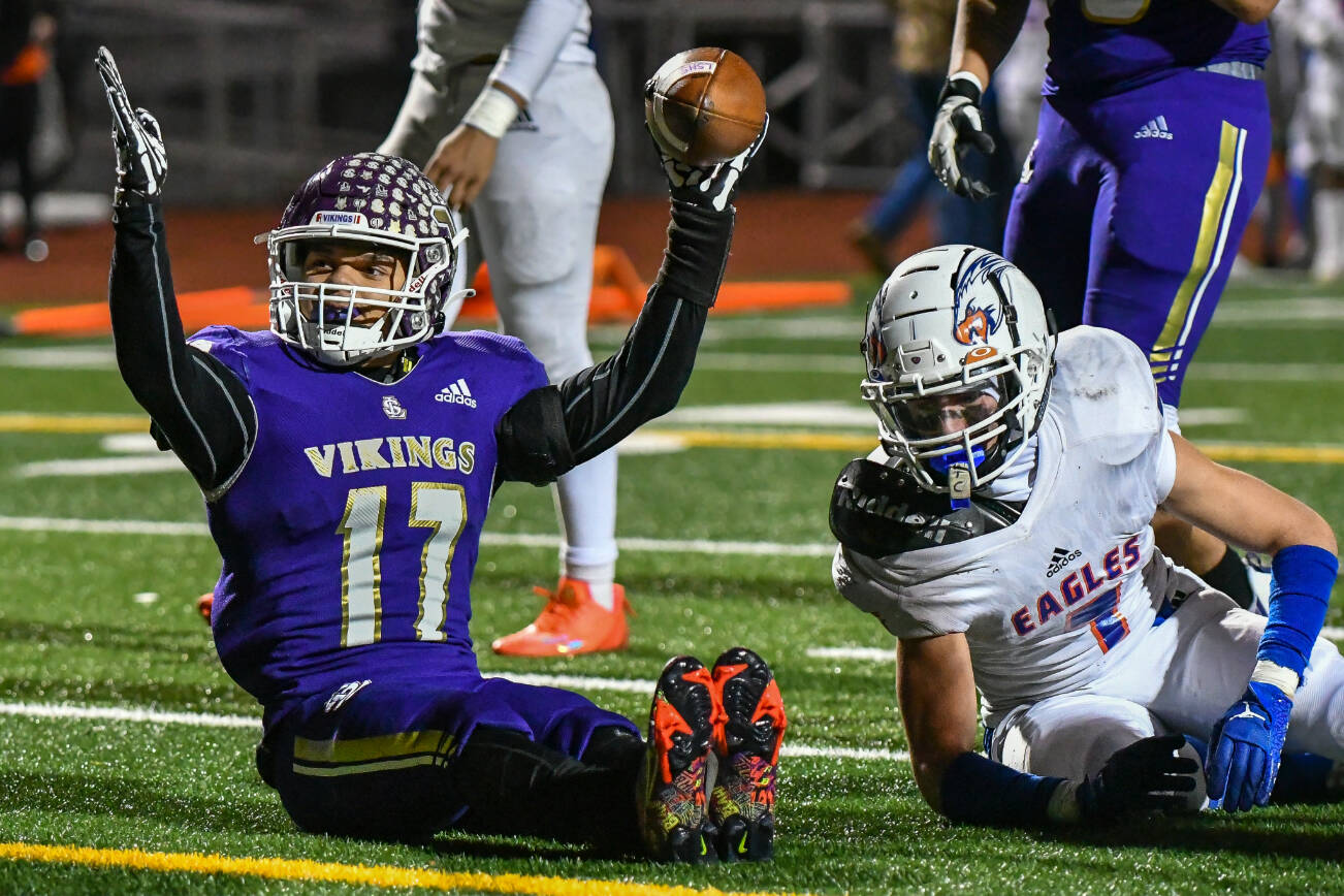 Lake Stevens running back Jayden Limar (left) signals after scoring a touchdown during a state playoff game against Graham-Kapowsin on Nov. 26, 2022, at Lake Stevens High School. (John Gardner / Pro Action Image)