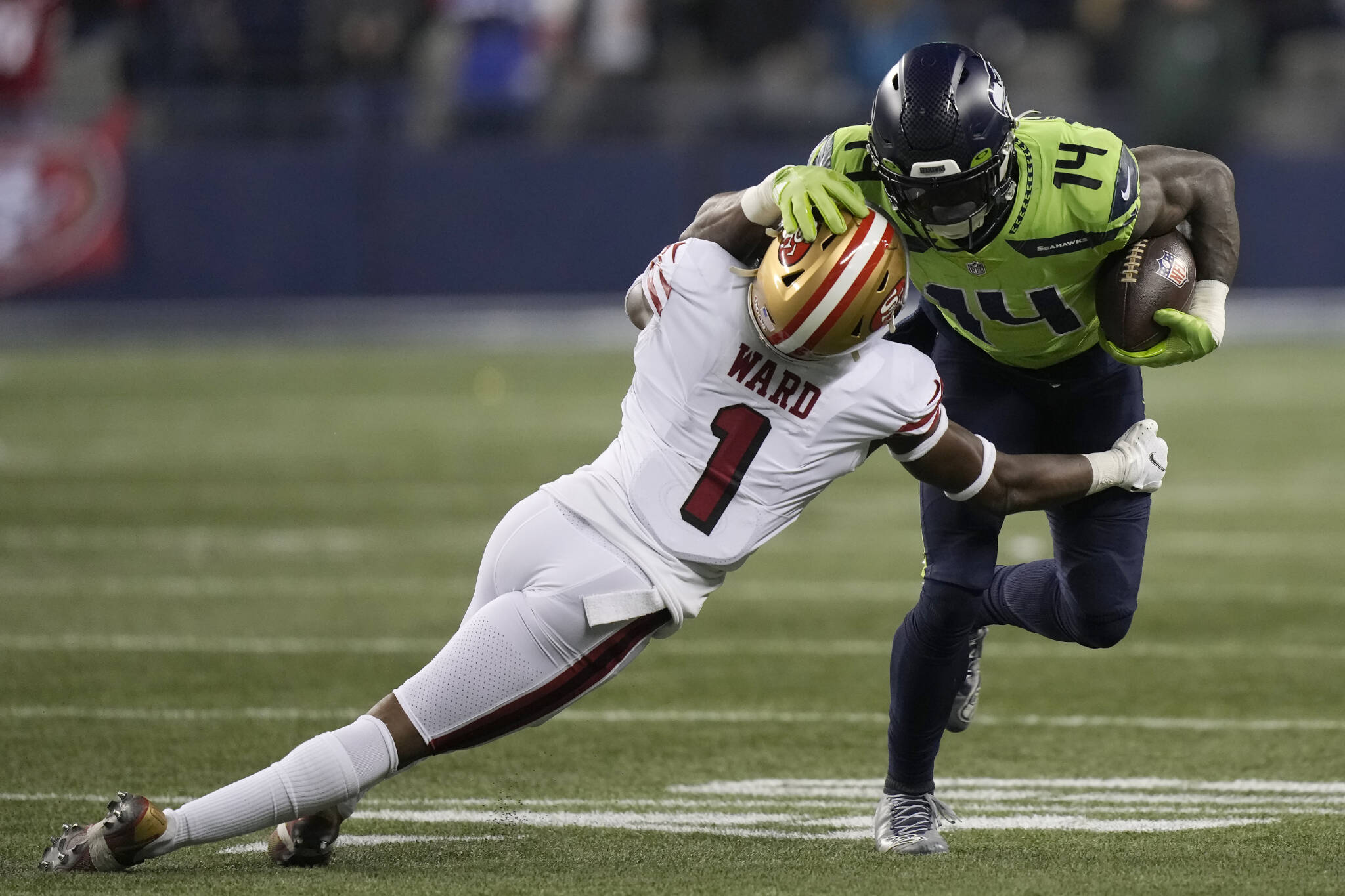 Seahawks wide receiver DK Metcalf (14) tries to slip past 49ers cornerback Jimmie Ward during the second half of a game Dec. 15 in Seattle. (AP Photo/Stephen Brashear)