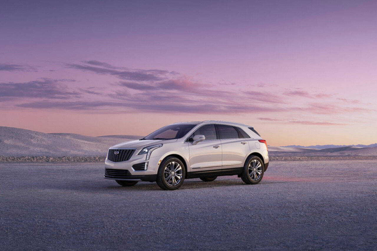 2023 Cadillac XT5 Premium Luxury shown in Crystal White Tricoat with 20” alloy wheels, front 3/4 angle. (Cadillac)
