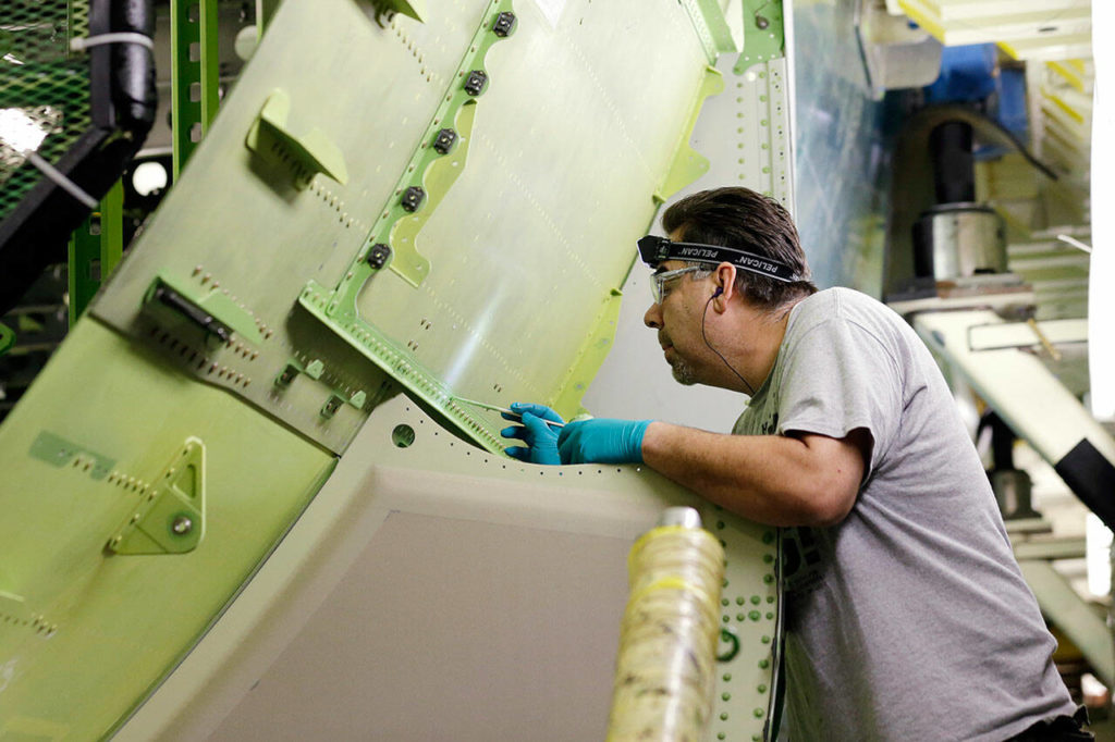 Boeing employee works on a Boeing 777 jet under construction on May 29, 2013, at the company’s production plant in Everett, Wash. (AP Photo / Elaine Thompson)
