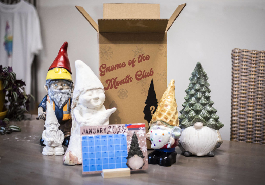 Each $30 box contains a gnome-inspired lawn ornament, along with a knick-knack like a mug, T-shirt, fridge magnet or bumper sticker, and a postcard-size calendar featuring that month’s gnome. (Olivia Vanni / The Herald)
