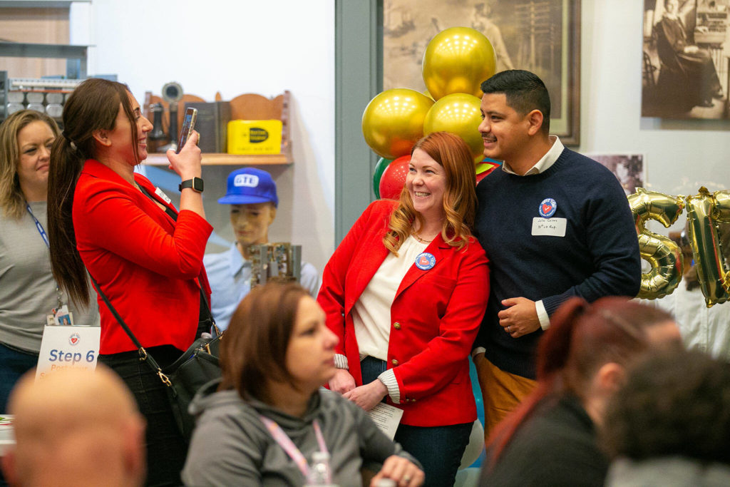 Outgoing Representative of the 38th District Emily Wicks and her successor Julio Cortes take a photo together after both speaking during a campaign event in support of Marysville School District’s proposed levy on Jan. 5, at the Marysville Historical Society Museum in Marysville. (Ryan Berry / The Herald) 
