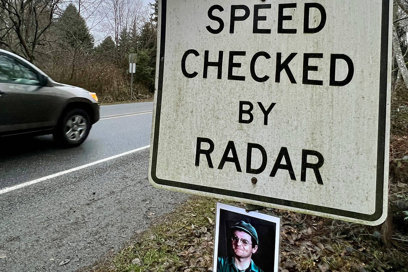 A photo of “M*A*S*H” character Corporal Walter "Radar" O’Reilly has mysteriously returned to the “Speed Checked by Radar” sign on Third Street coming into Langley on Whidbey Island on Jan. 2, 2023. (Andrea Brown / The Herald)