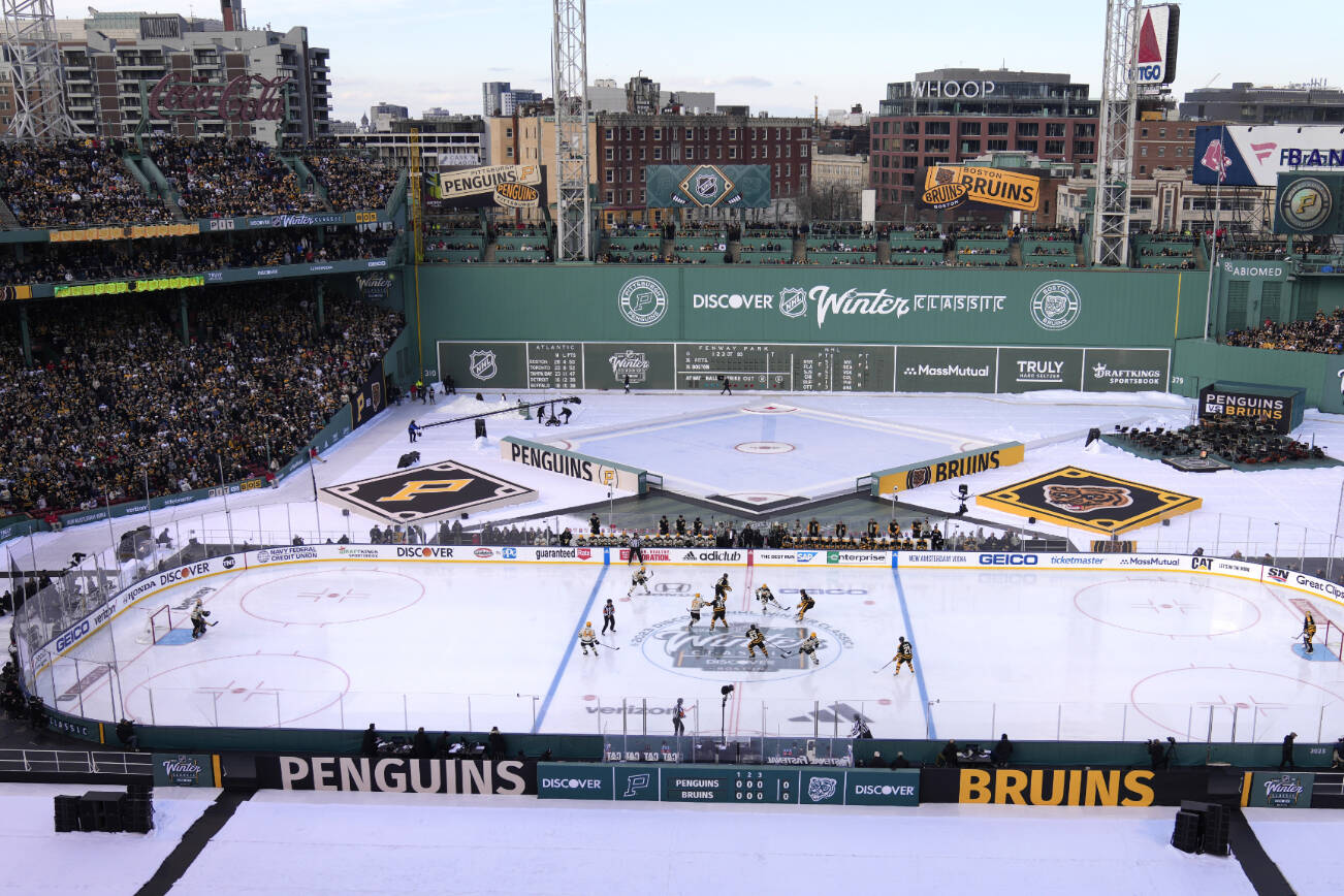 The Pittsburgh Penguins play against the Boston Bruins during the first period of the NHL Winter Classic hockey game at Fenway Park, Monday, Jan. 2, 2023, in Boston. (AP Photo/Charles Krupa)