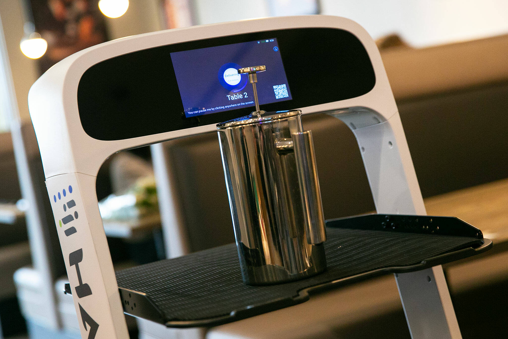 Peanut the server robot takes a tea press to table 2 while serving tables at Sushi Hana on Jan. 5, in Lynnwood. (Ryan Berry / The Herald)