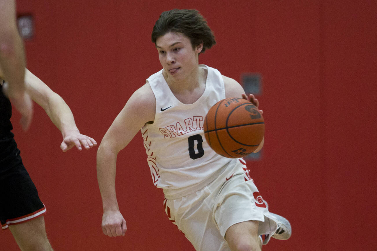 Stanwood's Owen Thayer takes the ball down the court during the game against Mountlake Terrace on Thursday, Jan. 20, 2022 in Stanwood, Washington. (Olivia Vanni / The Herald)