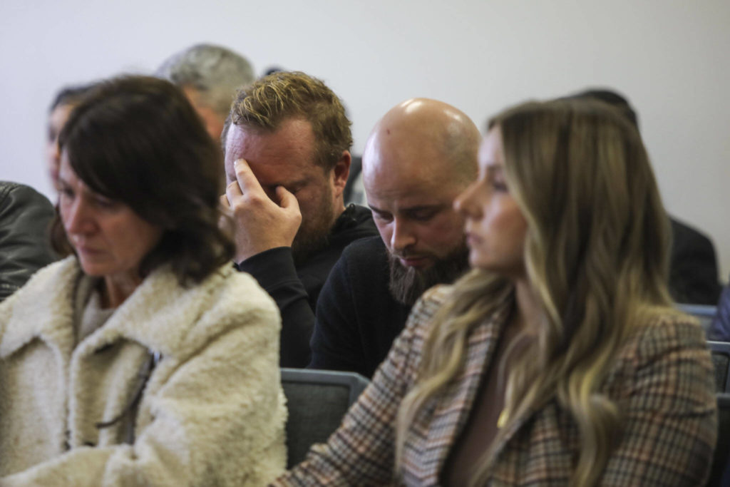 People listen and react in the courtroom during the sentencing of Ilya Hrudzko, who drove into a tree in Stanwood in 2020 and killed his passenger, on Monday at Snohomish County Superior Court in Everett. (Annie Barker / The Herald)
