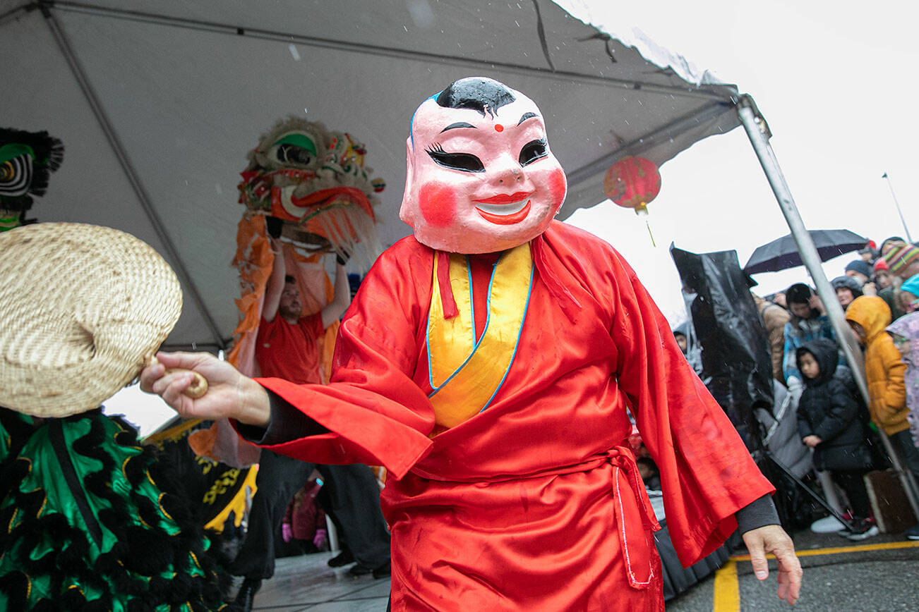 A big head Buddha turns to the crowd during a celebration of the Lunar New Year on Saturday, Jan. 21, 2023, in downtown Edmonds, Washington. (Ryan Berry / The Herald)