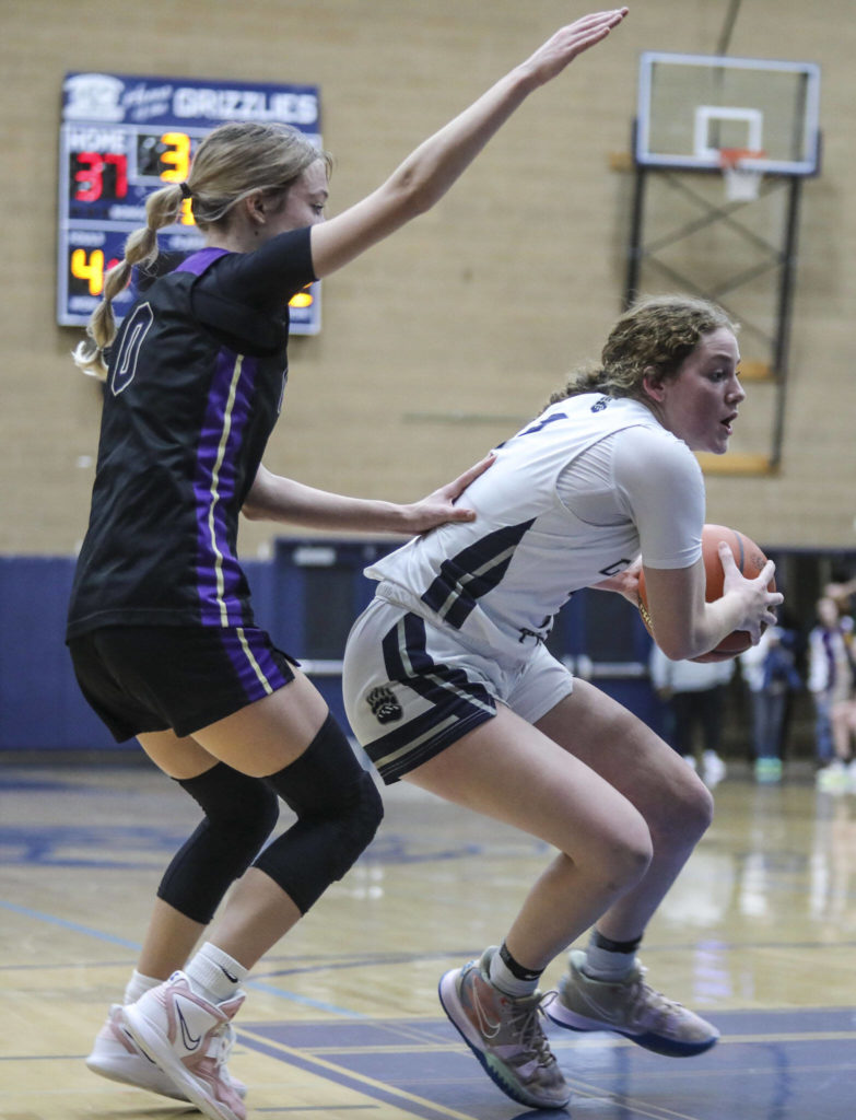 Lake Stevens’ Ella Edens (0) chases after Glacier Peak’s Brynna Pukis during a game between the Lake Stevens Vikings and Glacier Peak Grizzlies on Friday in Snohomish. The Grizzlies won 51-32. (Annie Barker / The Herald)
