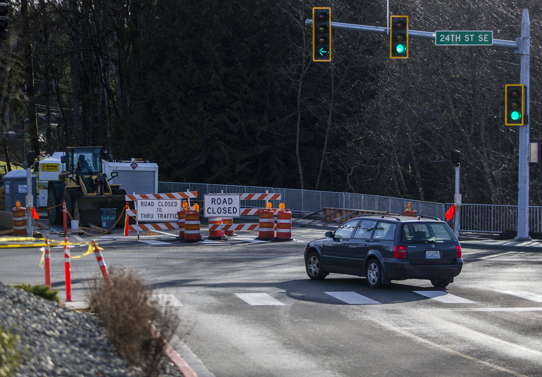 Drivers from Costco turn onto 24th Street SE past a closed South Lake Stevens Road on Tuesday in Lake Stevens. That segment of South Lake Stevens Road is expected to open in February. (Olivia Vanni / The Herald)