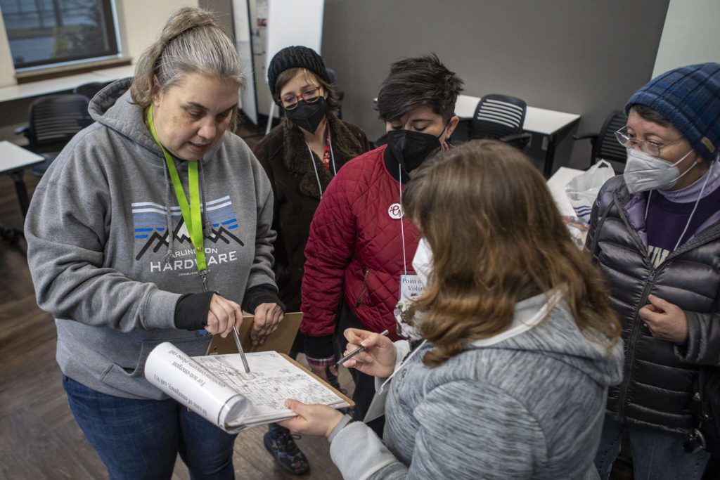 Catholic Community Services NW Director of Housing Services and Everett Family Center Director Rita Jo Case, left, instructs volunteers on where to go during a point-in-time count of people facing homelessness on Tuesday, in Everett. (Annie Barker / The Herald)
