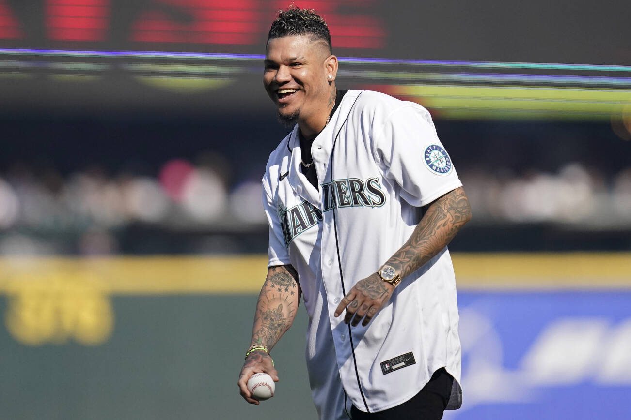 Former Seattle Mariners pitcher Felix Hernandez throws out the first pitch before Game 3 of an American League Division Series baseball game between the Seattle Mariners and the Houston Astros, Saturday, Oct. 15, 2022, in Seattle. (AP Photo/Abbie Parr)