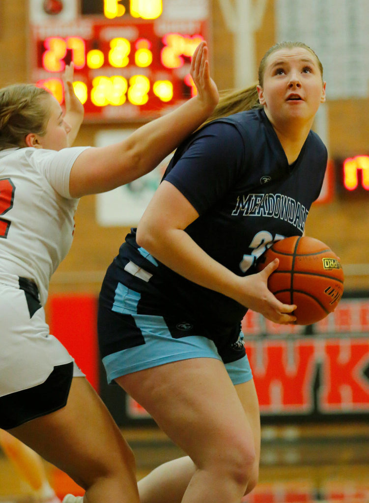 Meadowdale’s Audrey Lucas turns to the basket for a shot against Mountlake Terrace on Wednesday, Jan.11, 2023, at Mountlake Terrace High School in Mountlake Terrace, Washington. (Ryan Berry / The Herald)
