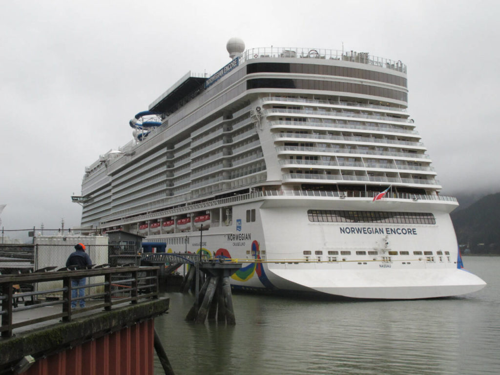 Alaska cruises can either be aboard large ships — such as the 4,000-passenger Norwegian Encore, seen here docked in Juneau — or smaller vessels that bring you closer to the water but don’t have amenities such as casinos. (Becky Bohrer / Associated Press)
