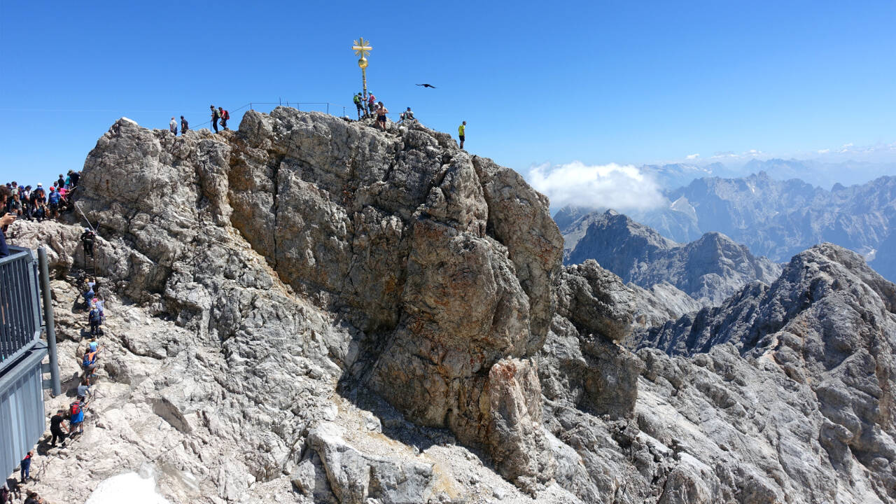 A golden cross marks the top of the 9,700-foot Zugspitze — the highest point in Germany. The mountain straddles the border between Germany and Austria, and lifts from both countries whisk visitors to the top.